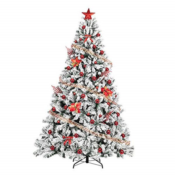 Snow flocked artificial Christmas tree decorated with red ornaments and a star topper