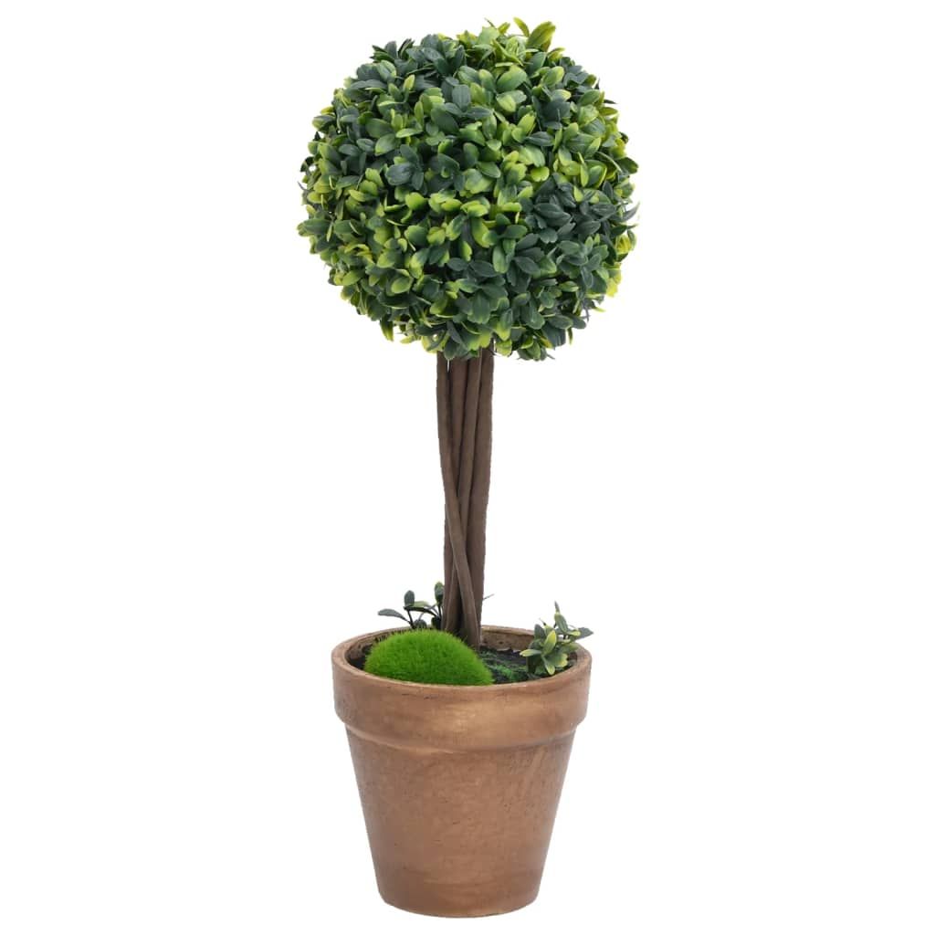 Artificial boxwood plants shaped as a round topiary in a brown pot with moss decoration