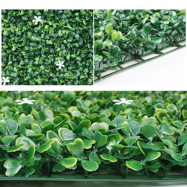 Close-up of FauxMart.com artificial boxwood hedge panels showing dense green leaves and white flowers