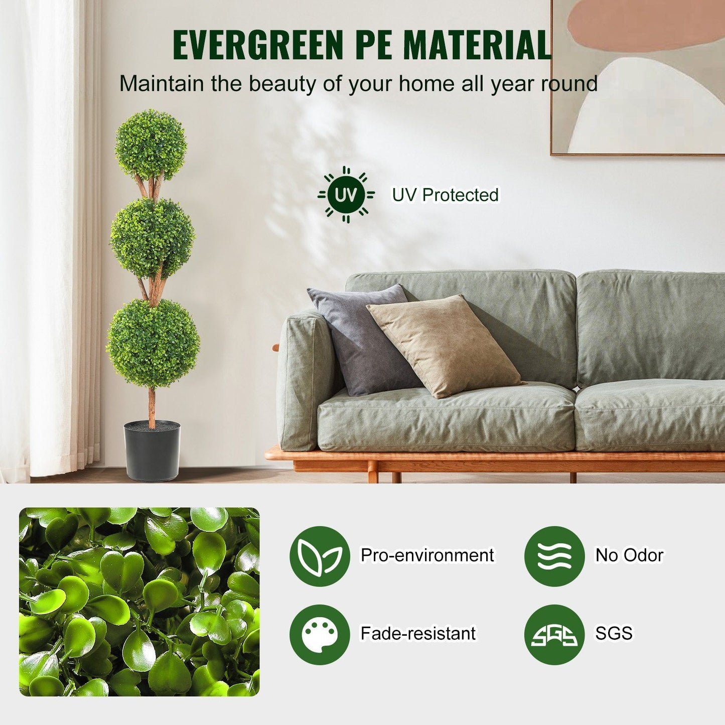 Faux boxwood trees set with three green artificial spheres in black pot placed beside a gray sofa in a modern living room
