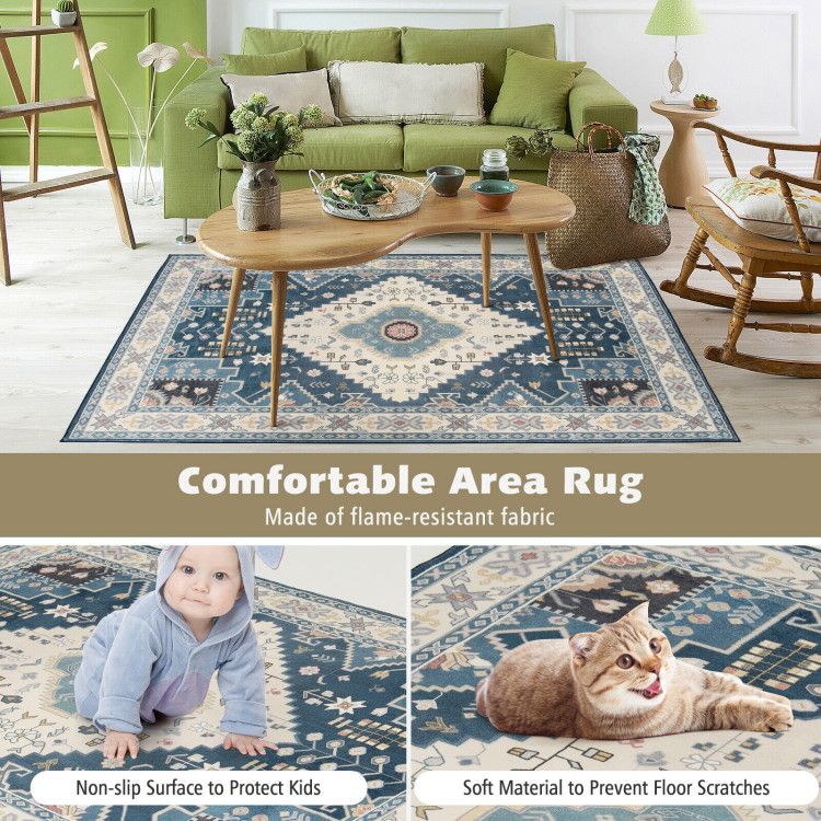 Blue and beige patterned faux wool area rugs in living room with green sofa and wooden coffee table