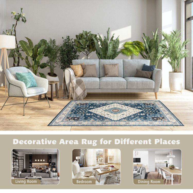 Faux wool area rugs in a modern living room with blue patterned rug, gray sofa, and green plants