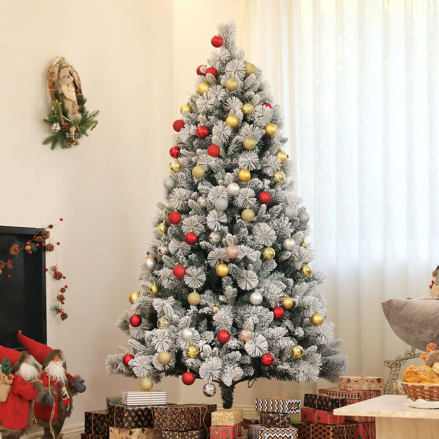 Pre-lit snow flocked Christmas tree decorated with red gold and silver ornaments in a cozy living room
