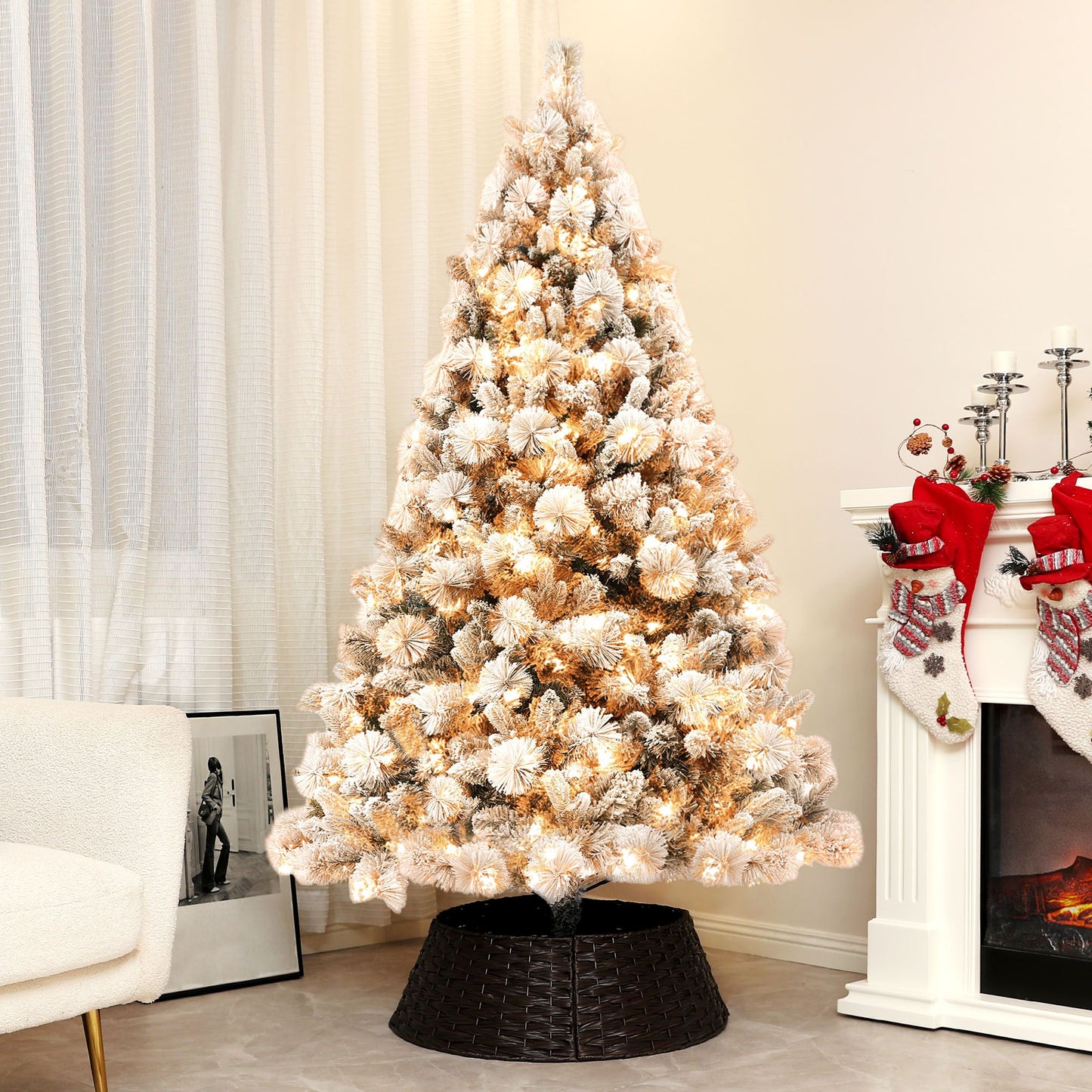 Pre-lit snow flocked Christmas tree with warm white lights in a cozy living room setting