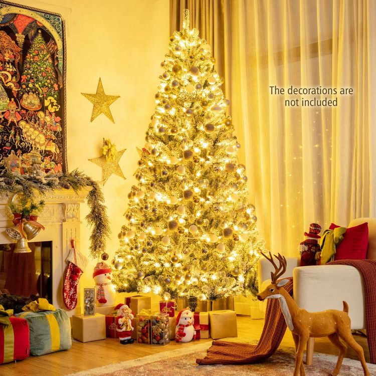 Pre-lit snow flocked Christmas tree decorated with warm white lights in cozy living room setting