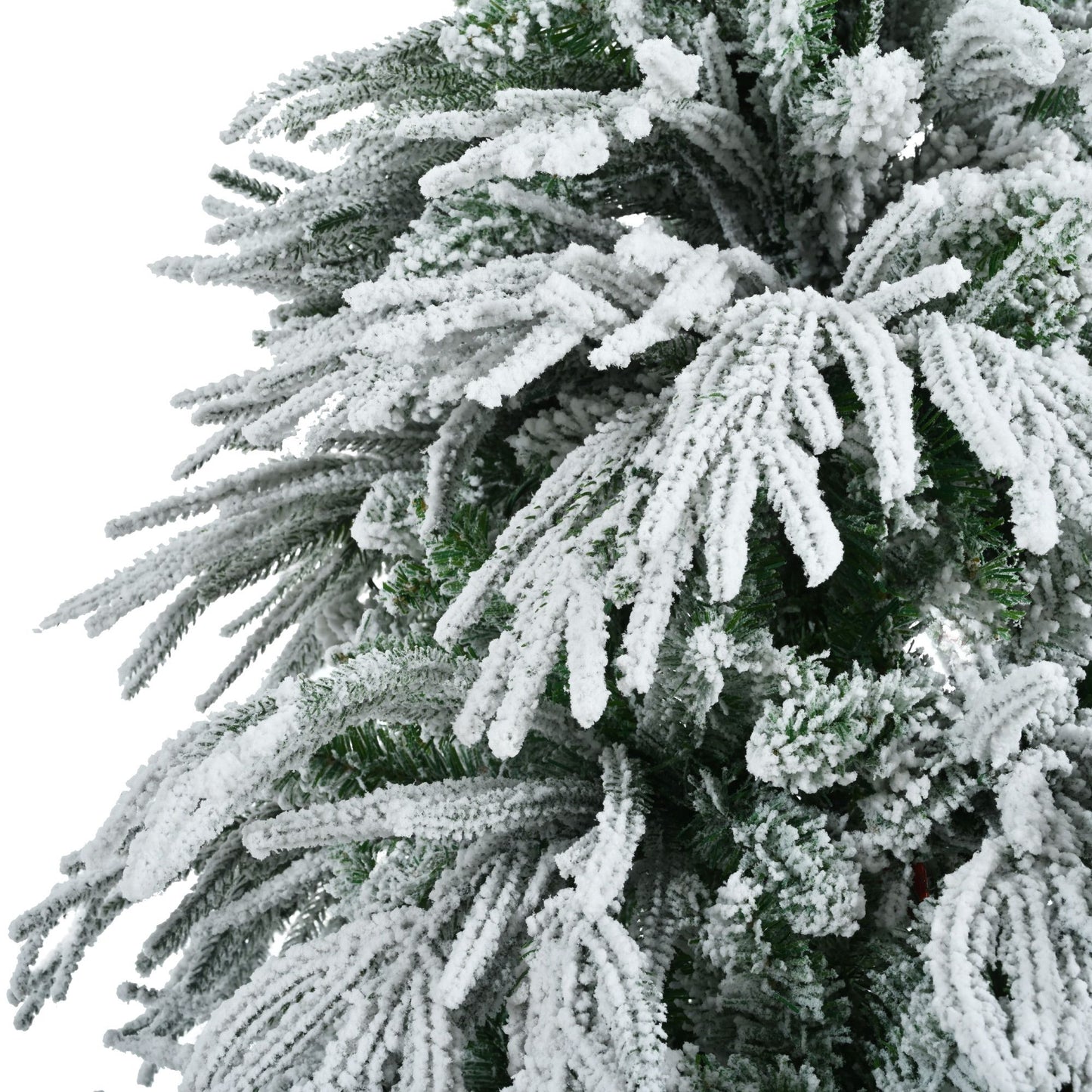 Close-up of pre-lit snow flocked Christmas tree set with realistic snowy branches from FauxMart.com