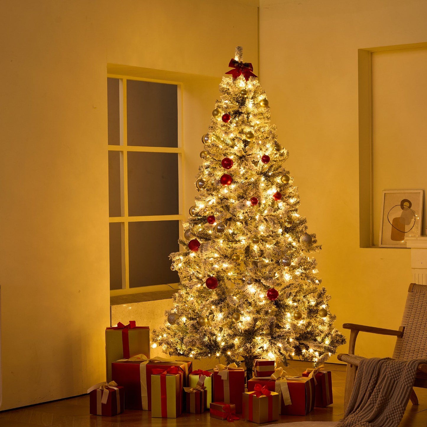 7.5 foot prelit flocked Christmas tree decorated with red and gold ornaments and surrounded by wrapped gifts in a cozy room