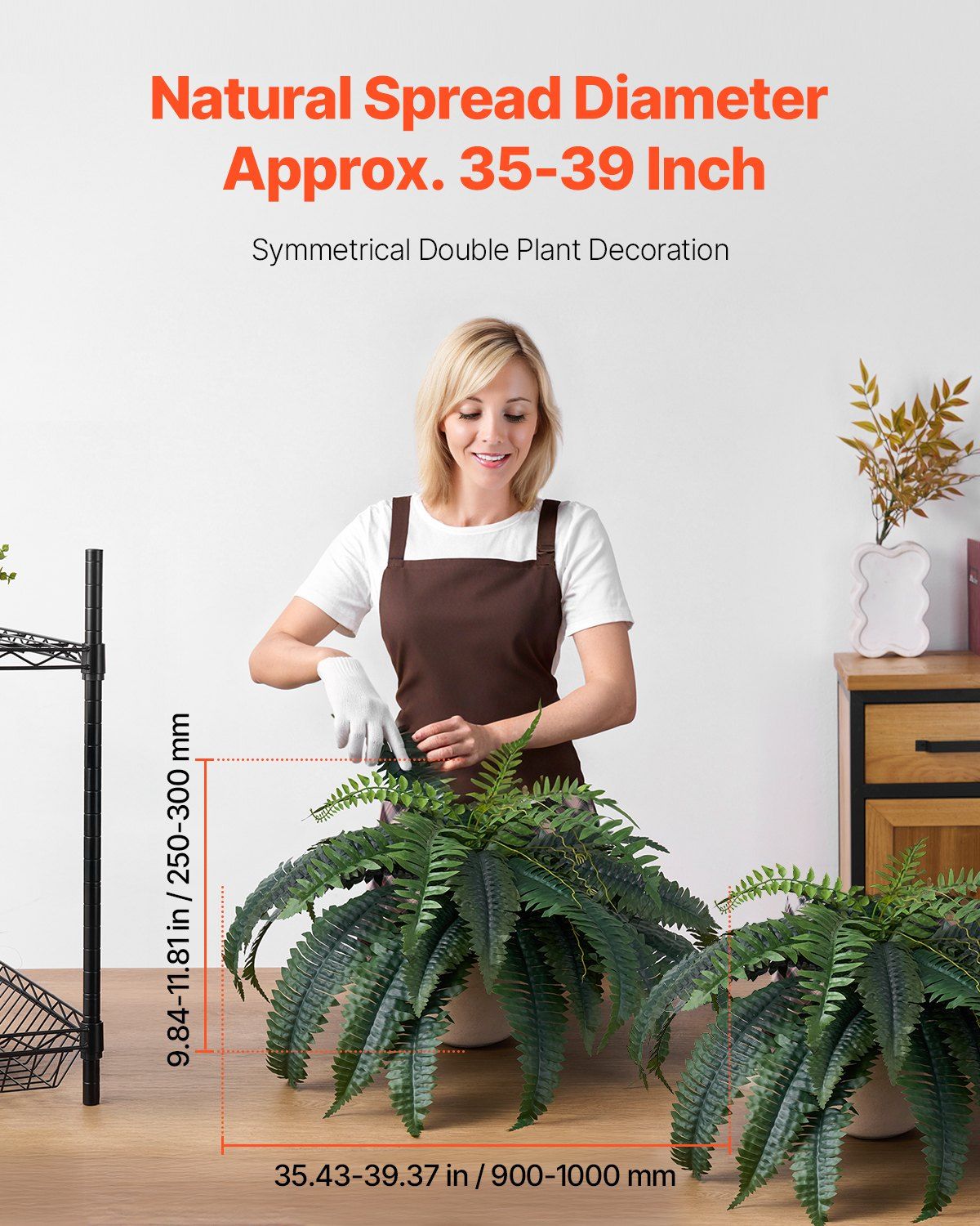 Artificial Boston fern set with natural spread diameter 35-39 inches displayed by woman in apron