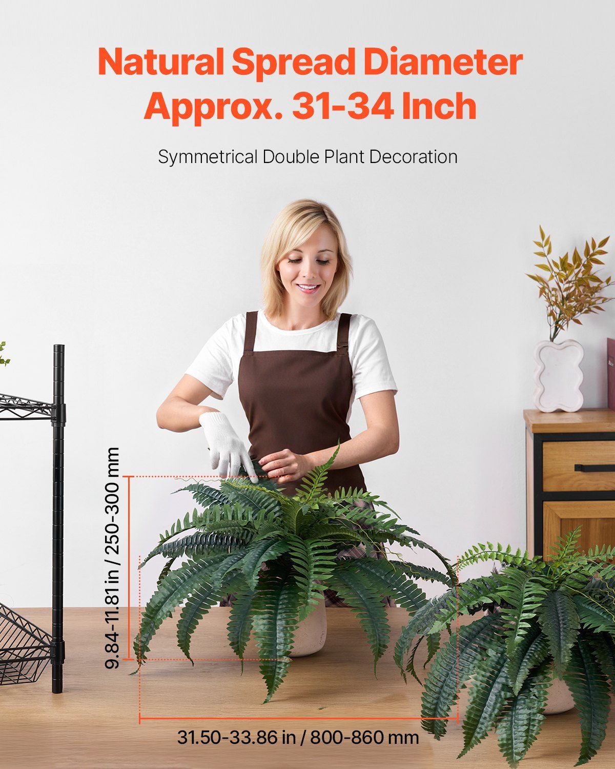 Artificial Boston ferns set with natural spread diameter displayed on table with woman arranging fern
