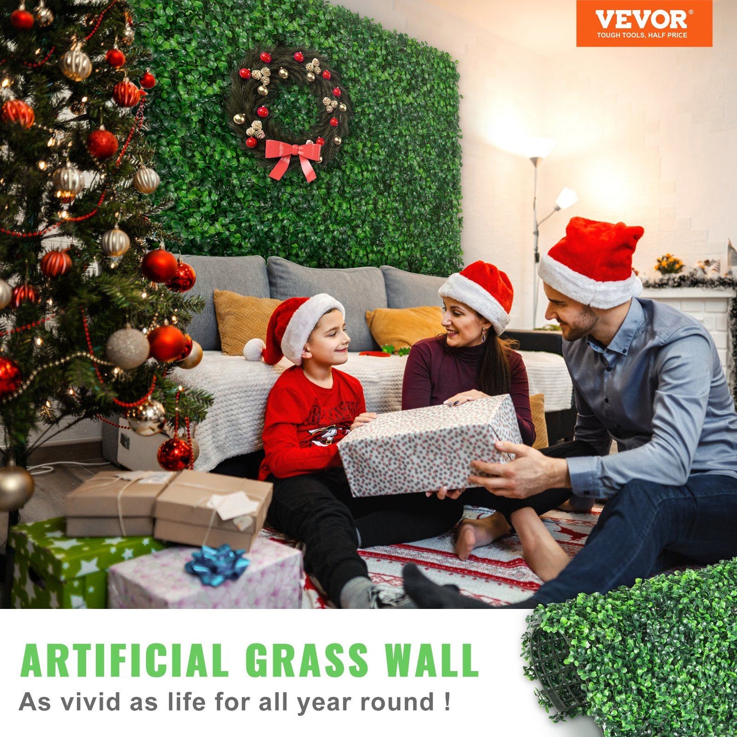 Family wearing Santa hats sitting near Christmas tree with artificial boxwood hedge panels on wall