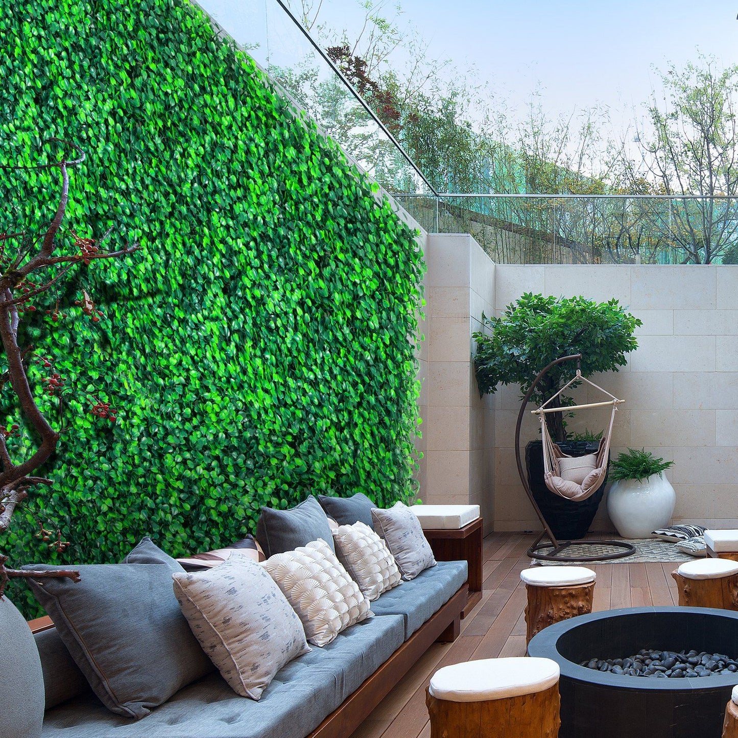Outdoor seating area with artificial boxwood hedge panels covering the wall for privacy and greenery