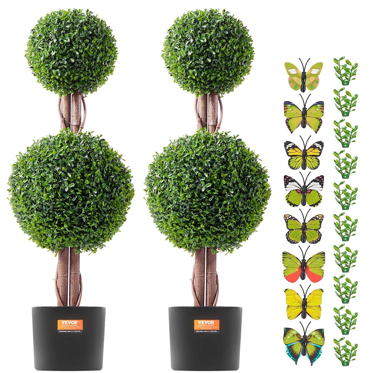 Two artificial boxwood topiary tree plants with round green foliage in black pots alongside decorative butterfly and leaf accessories