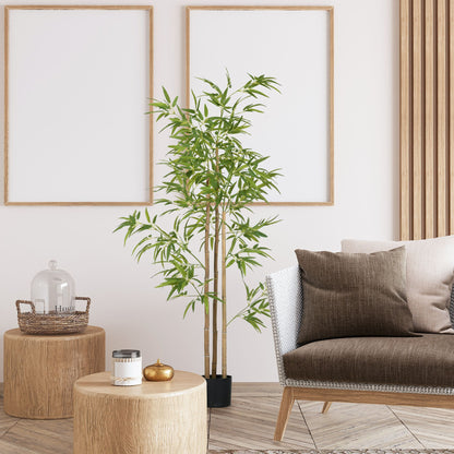 Artificial bamboo tree 6ft in black pot placed in a modern living room with wooden furniture and neutral decor