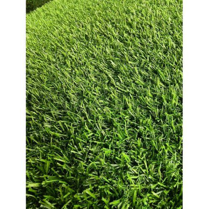 Close-up view of lush green artificial boxwood hedge panels with dense foliage texture