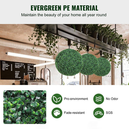 Three artificial boxwood topiary balls hanging in a modern cafe setting showcasing evergreen PE material