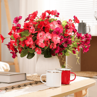Vibrant arrangement of artificial hibiscus flowers outdoor in a white vase, perfect for home decor