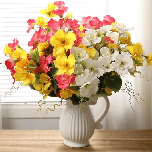 Vibrant artificial hibiscus flowers outdoor arrangement in a stylish white vase for home decoration