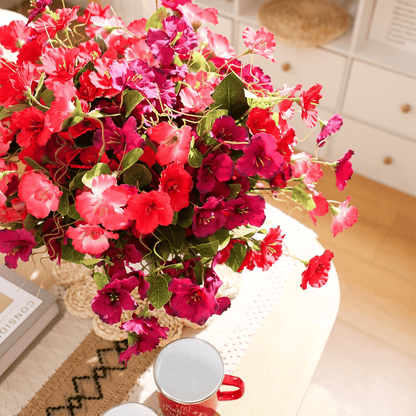 Vibrant artificial hibiscus flowers outdoor in a decorative vase for brightening home decor