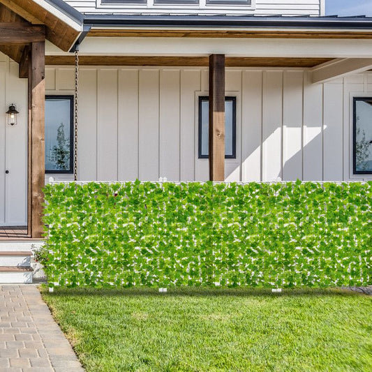 Artificial ivy privacy fence providing an aesthetic barrier in front of a stylish home