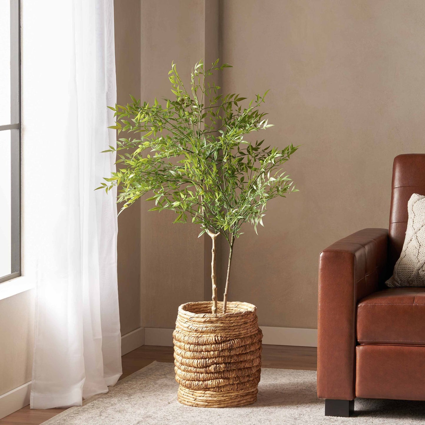 Elegant artificial nandina plant decor in a woven basket, perfect for enhancing home interiors