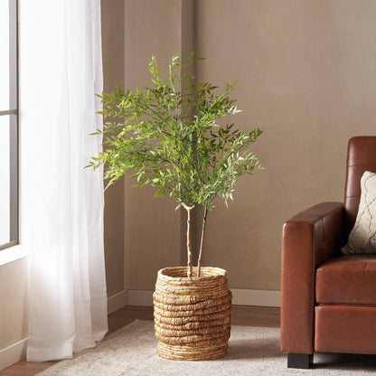 Elegant artificial nandina plant decor in a woven basket, perfect for enhancing home interiors