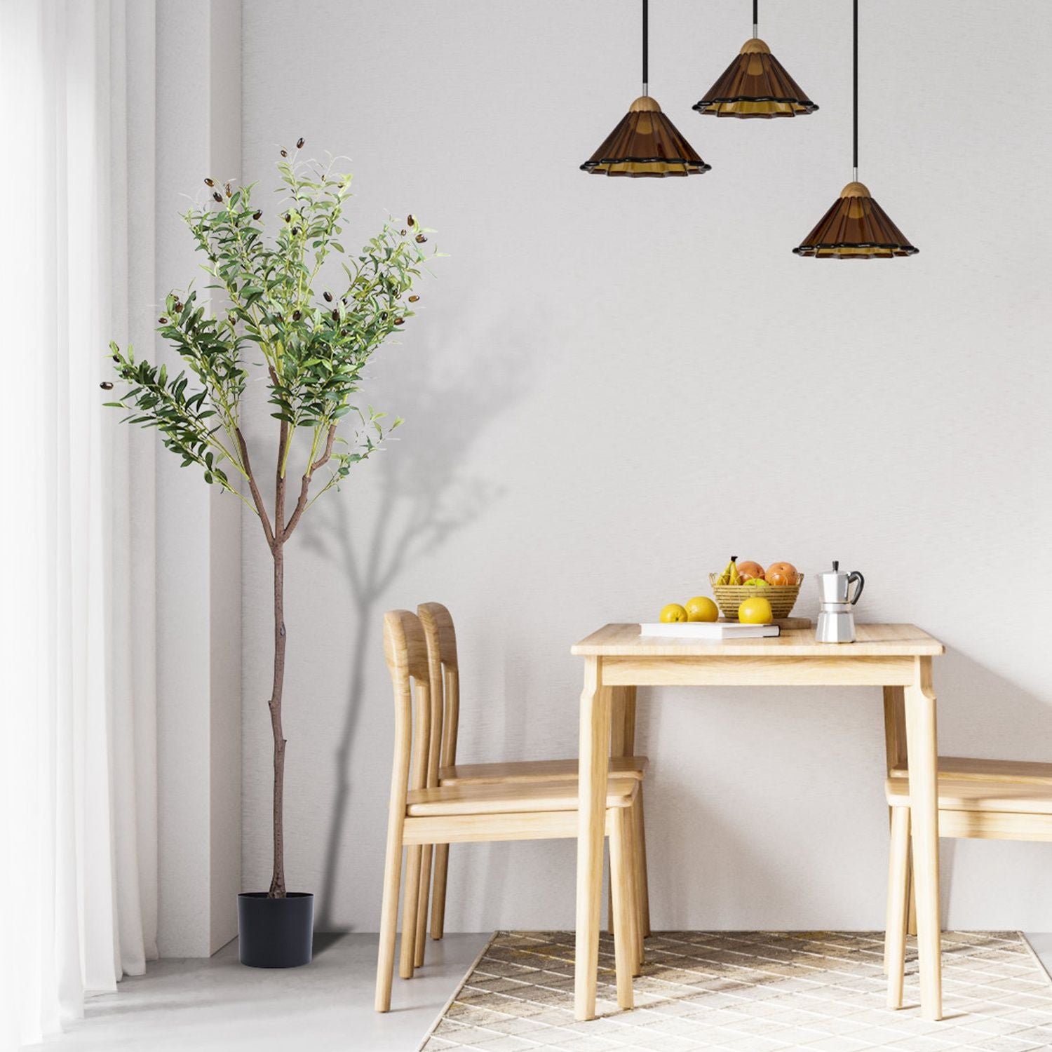 Artificial olive tree for home decor placed next to a wooden dining table with chairs in a bright room