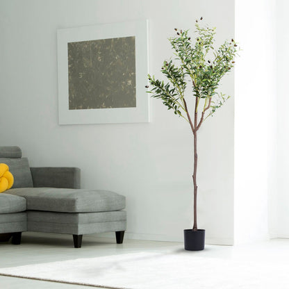 Tall artificial olive tree for home decor in a black pot next to a gray sectional sofa in a bright living room