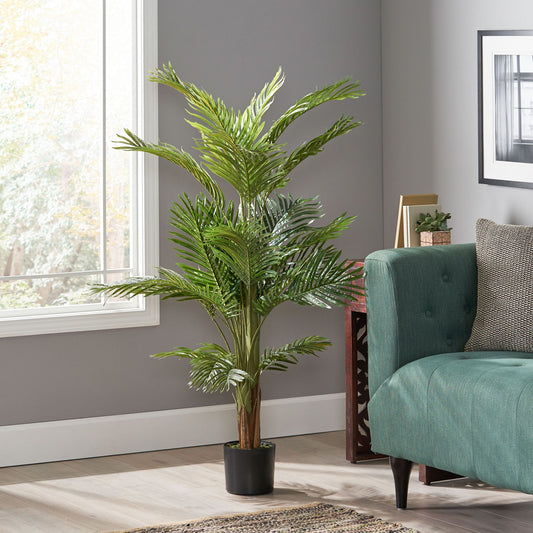51 inch artificial palm tree in a modern living room with a green couch and natural light