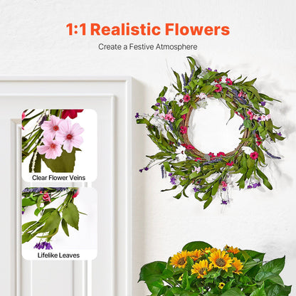 Artificial pink daisy wreath with lifelike leaves and clear flower veins hanging on white door