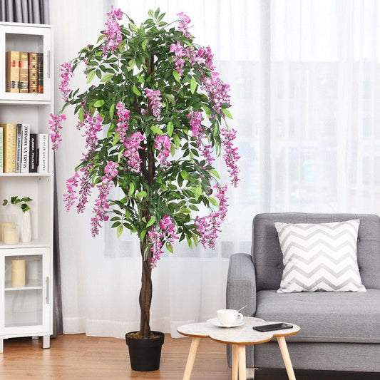 Artificial wisteria tree in a living room, featuring vibrant purple flowers and lush green leaves