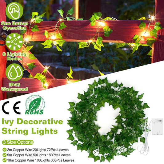 Artificial ivy string lights wrapped on wooden fence with glowing warm lights and green leaves decoration