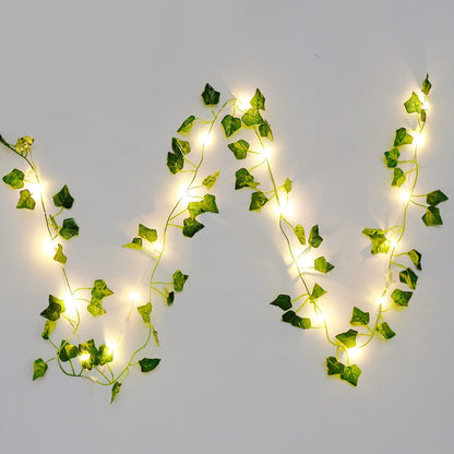 Warm glowing artificial ivy string lights with green leaves on a white background by FauxMart.com