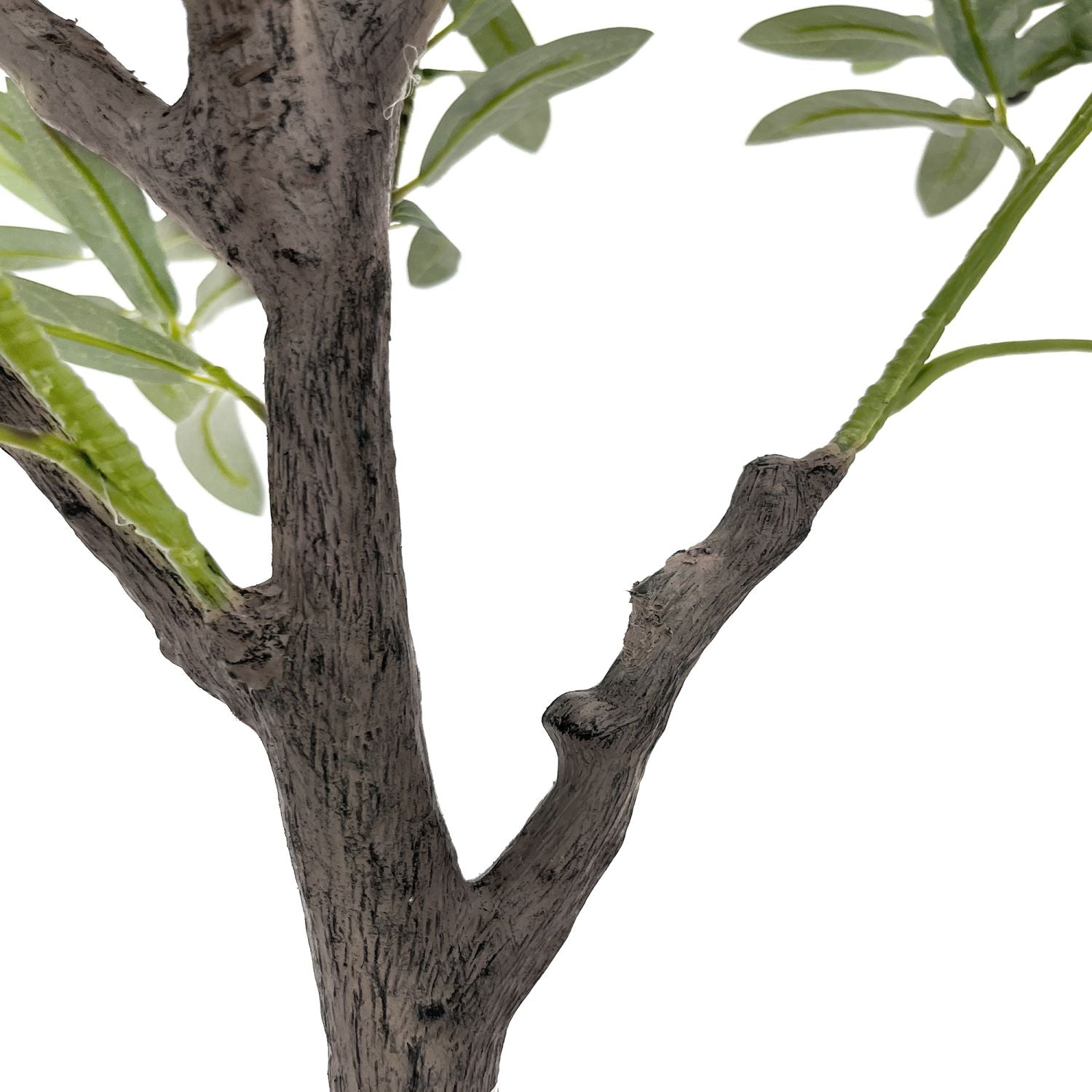 Close-up of a decorative faux olive tree branch with realistic green leaves and textured trunk