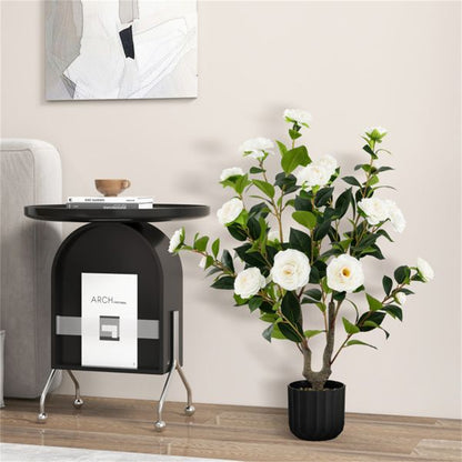Elegant faux camellia trees in a stylish pot beside a modern side table in a cozy living room