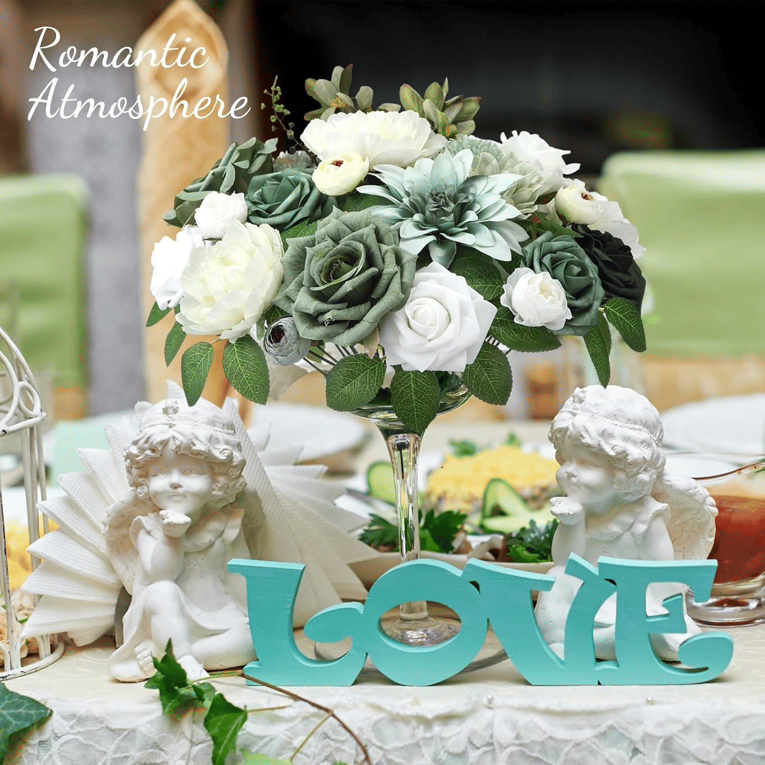 White and green artificial flower arrangement centerpiece with decorative love sign and angel statues