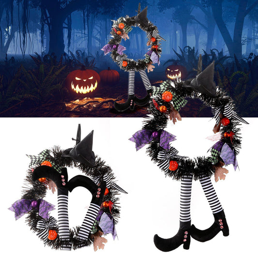 Halloween witch wreath with black and white striped legs, purple bows, orange pumpkins, and witch hat decoration