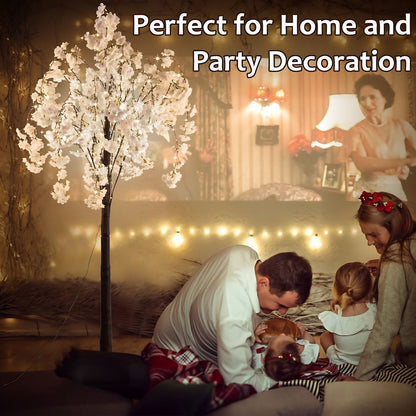 Lighted cherry blossom tree decor glowing in cozy living room with family enjoying home and party setting