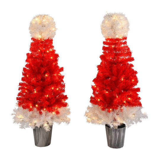 Red and white lighted santa hat christmas tree with warm white lights in a black pot