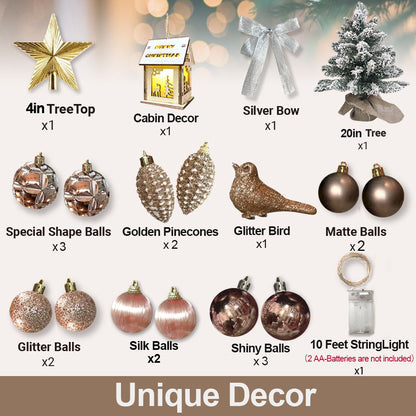 Mini tabletop Christmas tree with lights and decorative ornaments including silver bow, golden pinecones, glitter bird, and string lights