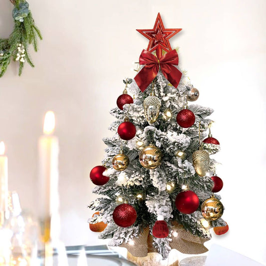 Mini tabletop Christmas tree with lights decorated with red ornaments and a red star topper