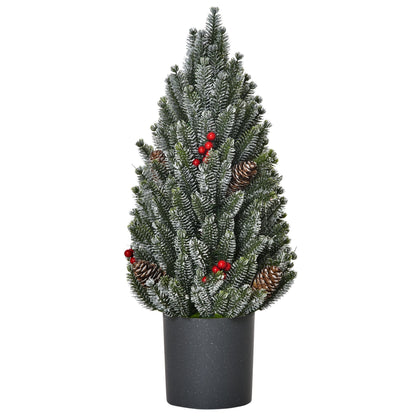 Miniature snow flocked Christmas tree with pinecones and red berries in a black pot for holiday decor