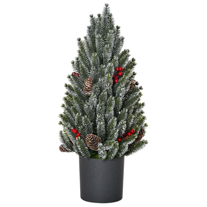 Miniature snow flocked Christmas tree adorned with pinecones and red berries in a black pot