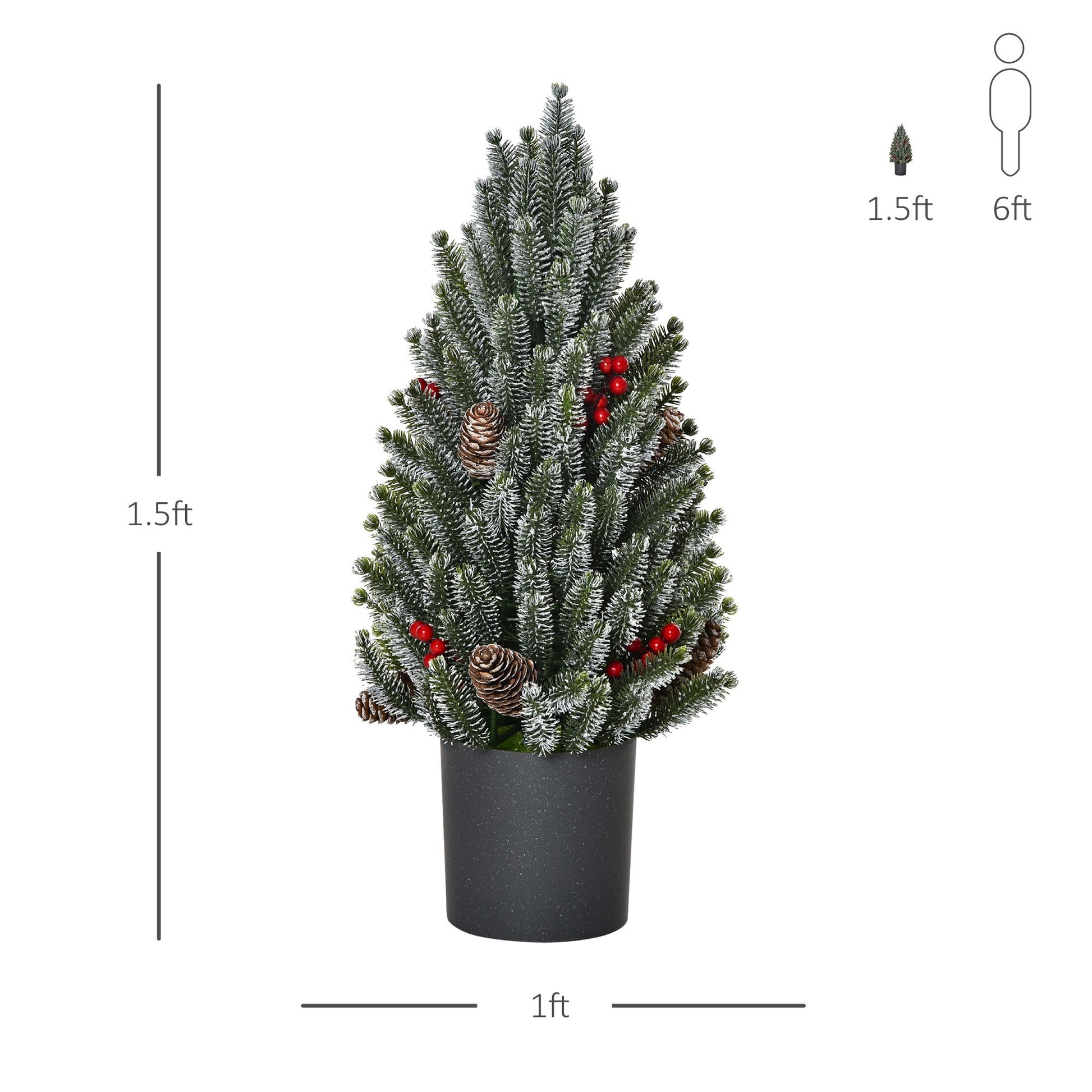 Miniature snow flocked Christmas tree decorated with pinecones and red berries in a black pot
