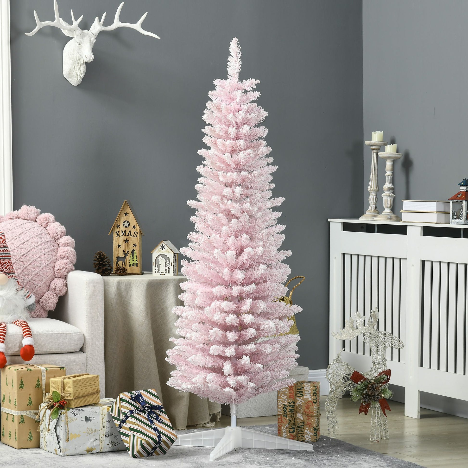 Pink artificial pencil Christmas tree standing in a modern living room with holiday decor and wrapped gifts