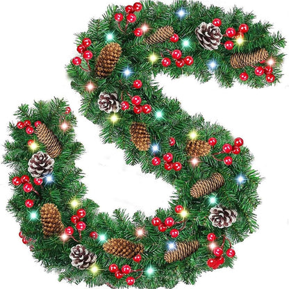 Prelit artificial Christmas garland decorated with pinecones and red berries for holiday decoration