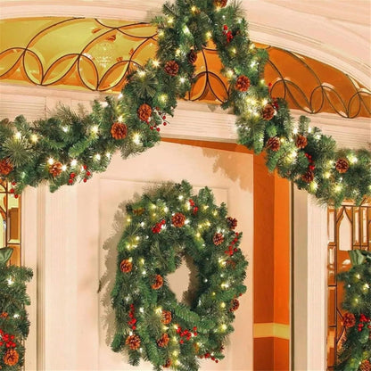 Prelit artificial Christmas garland adorned with pinecones and red berries for festive holiday decor