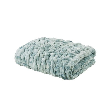 Soft light gray ruched faux fur throw blanket neatly folded for cozy home decor