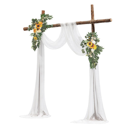 Sunflower wedding arch decor with white draped fabric and green foliage on rustic wooden frame