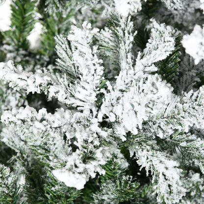 Close-up of unlit flocked Christmas tree for sale showing snowy white artificial snow on green pine needles