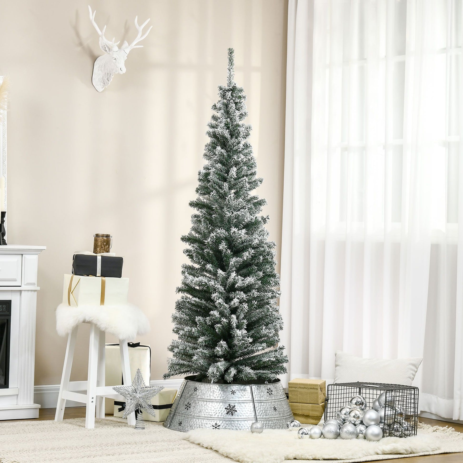 6 foot snow flocked Christmas tree with metal stand in a cozy living room decor setup